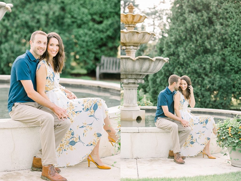 Couple sitting on fountain for sunrise engagement photos