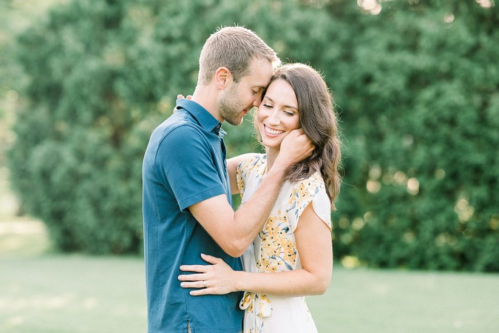 Groom nuzzles bride for engagement picture