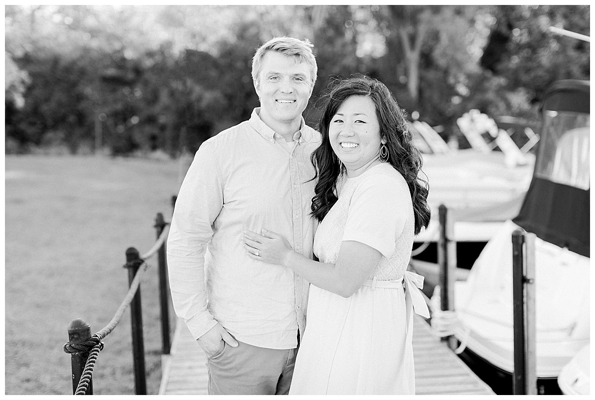couple smiling on dock for engagement session