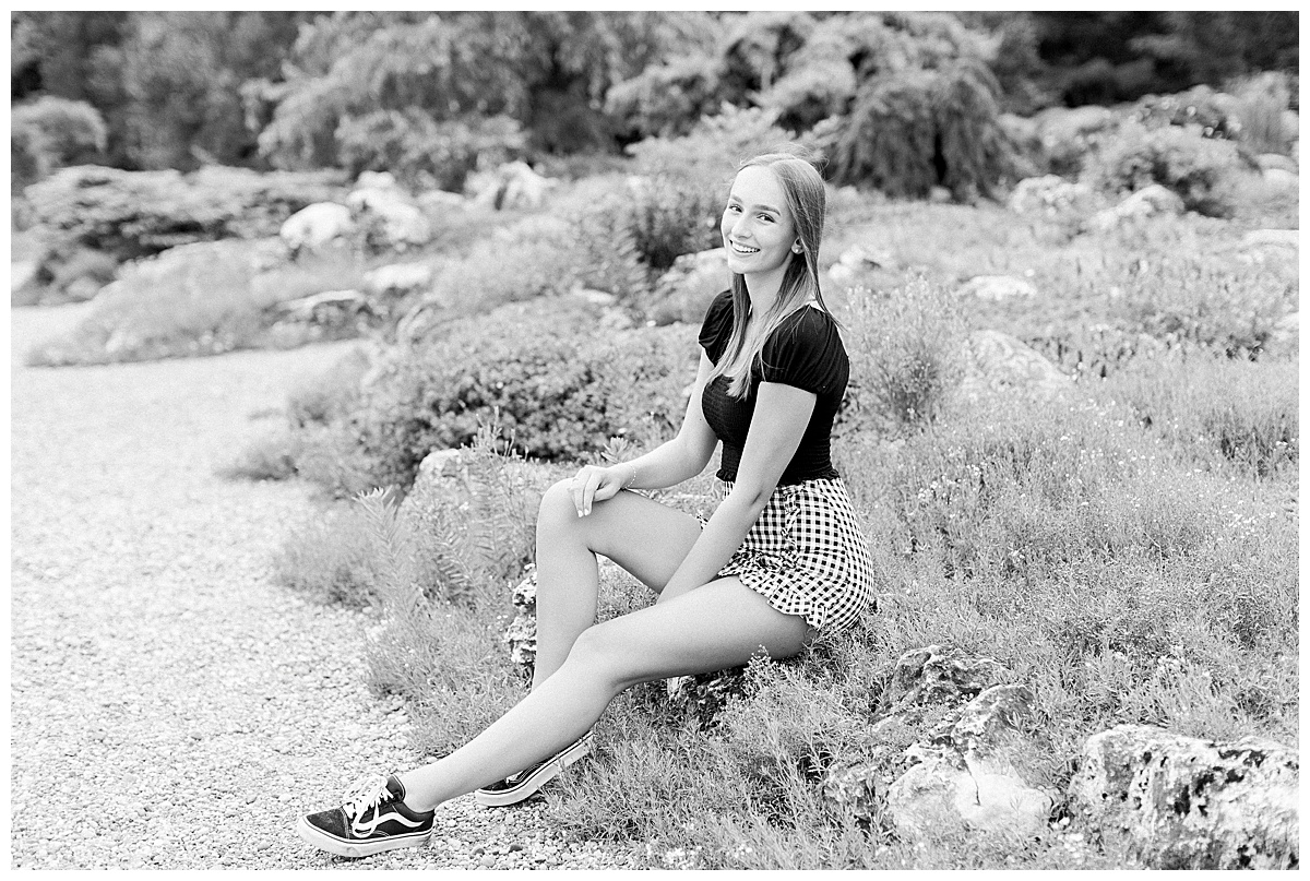 girl sitting on a rock for senior photos