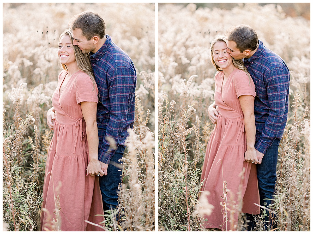 engaged couple cuddling in field