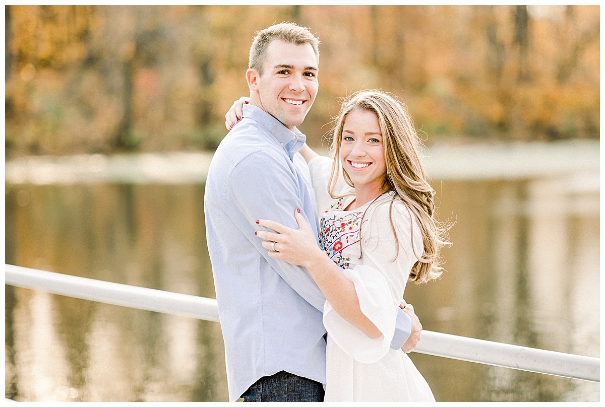 couple smiling on dock for engagement photos