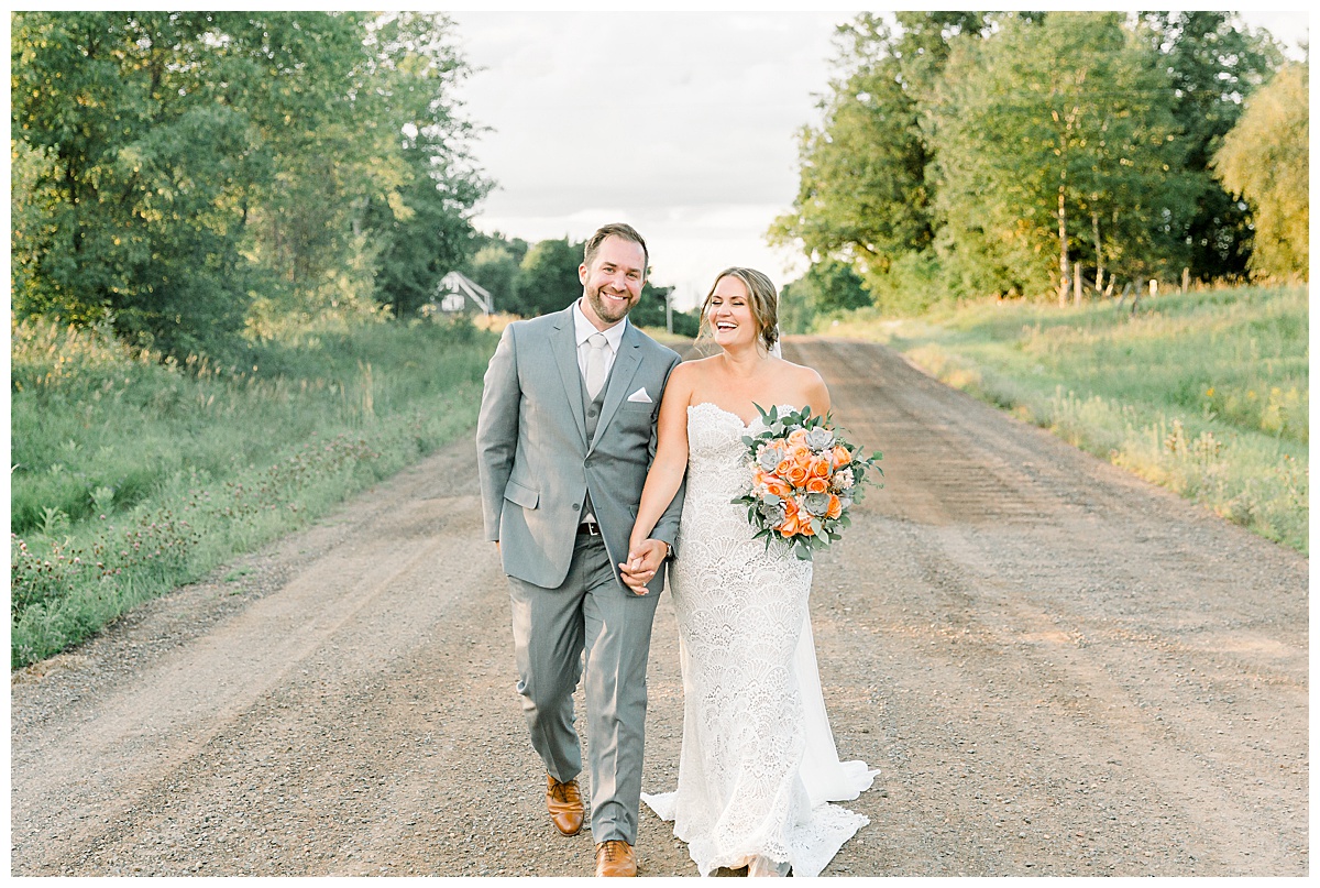 bride and groom walking down gravel road