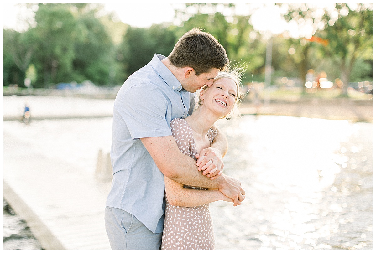 Couple hugging for beachside engagement photos
