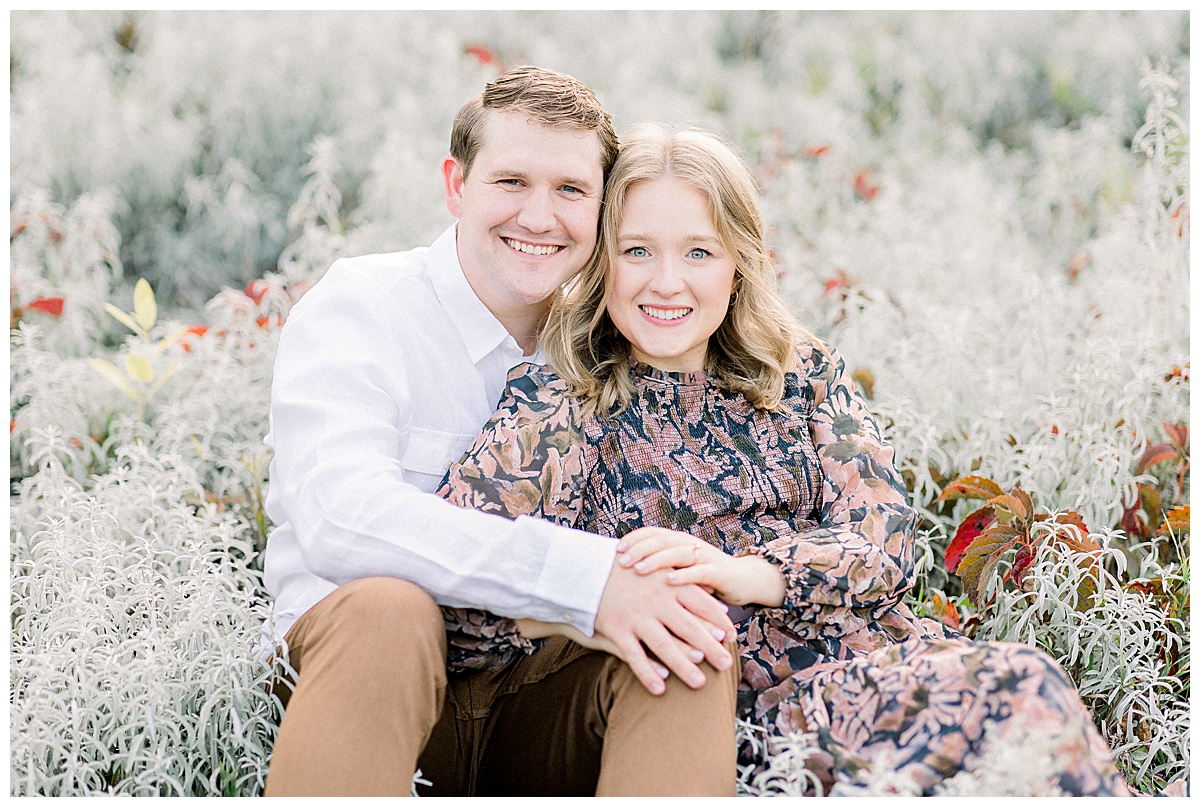 couple posing in field of flowers