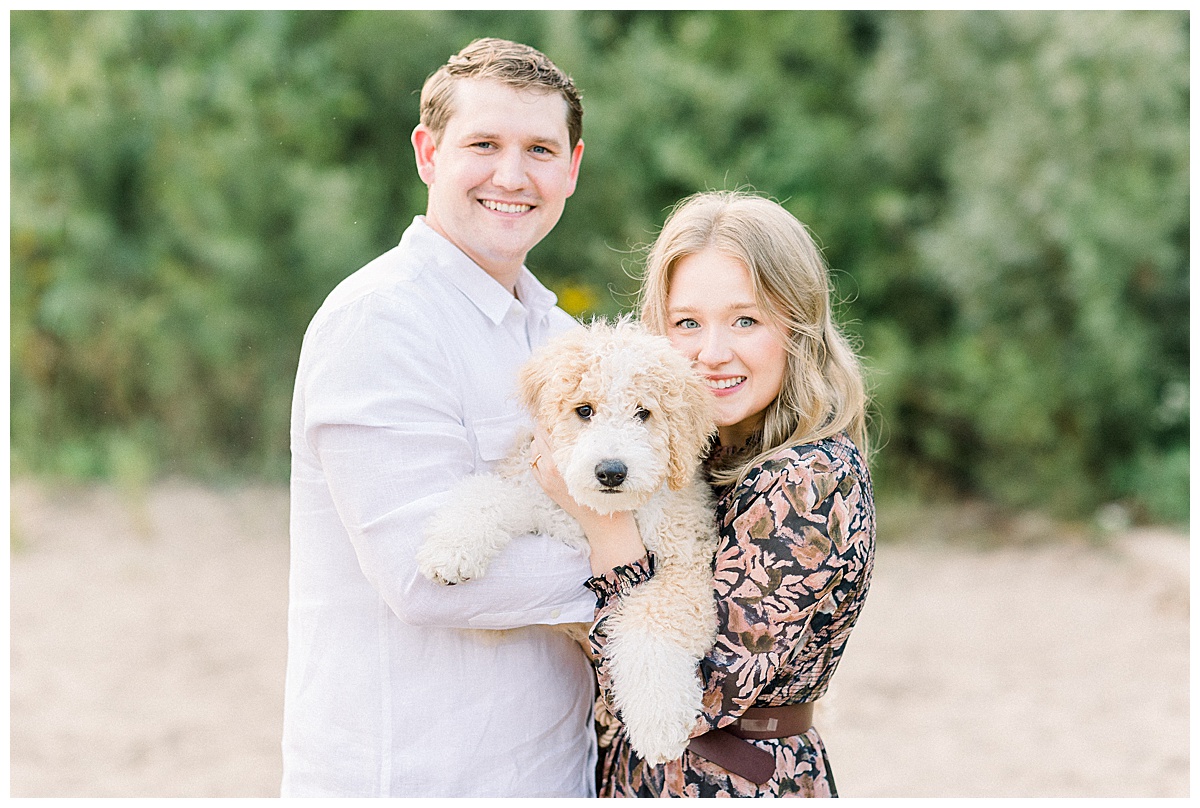 couple on beach with dog for engagement photos