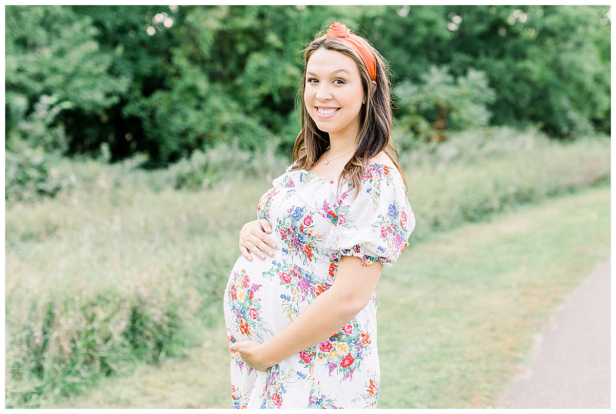 woman holding pregnant belly for maternity session