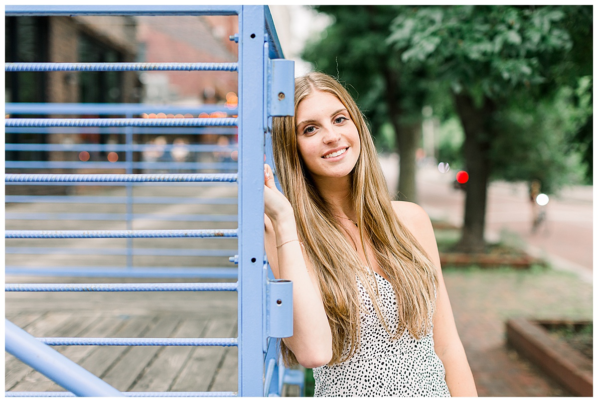 girl leaning on railing for senior photos