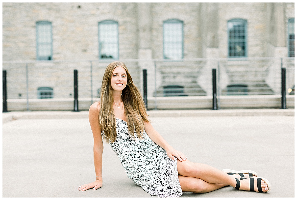 girl lounging on ground for senior photos