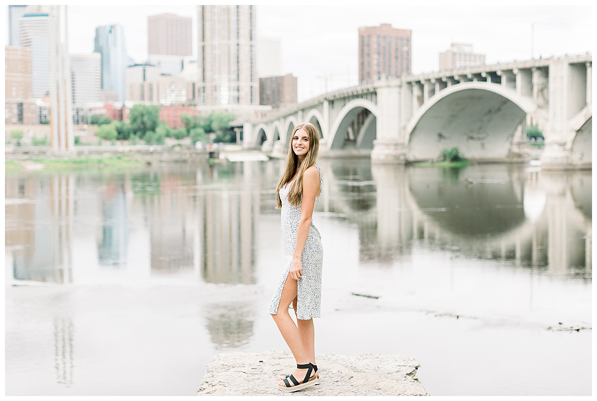girl standing in front of bridge