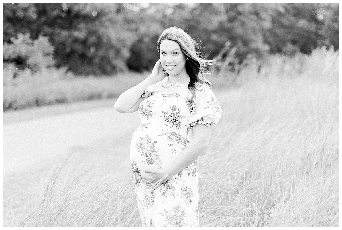 pregnant woman smiling in a field