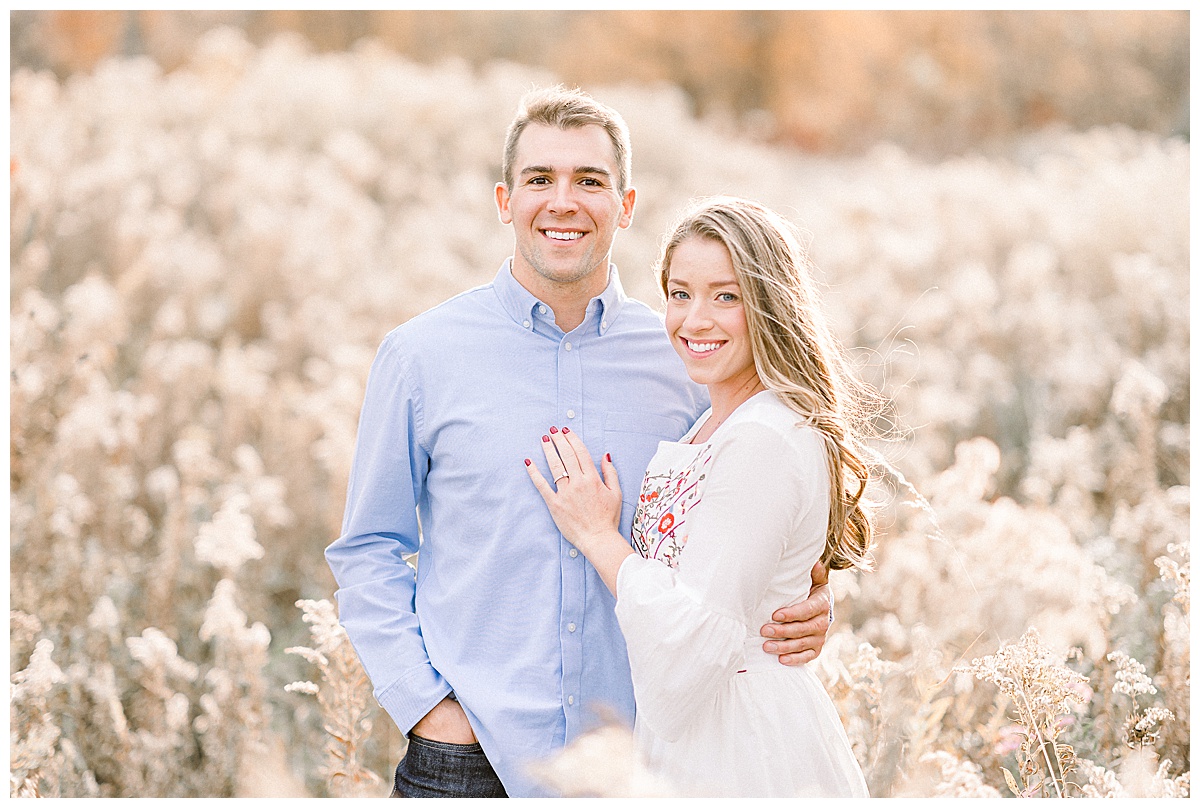 couple smiling for fall engagement photos